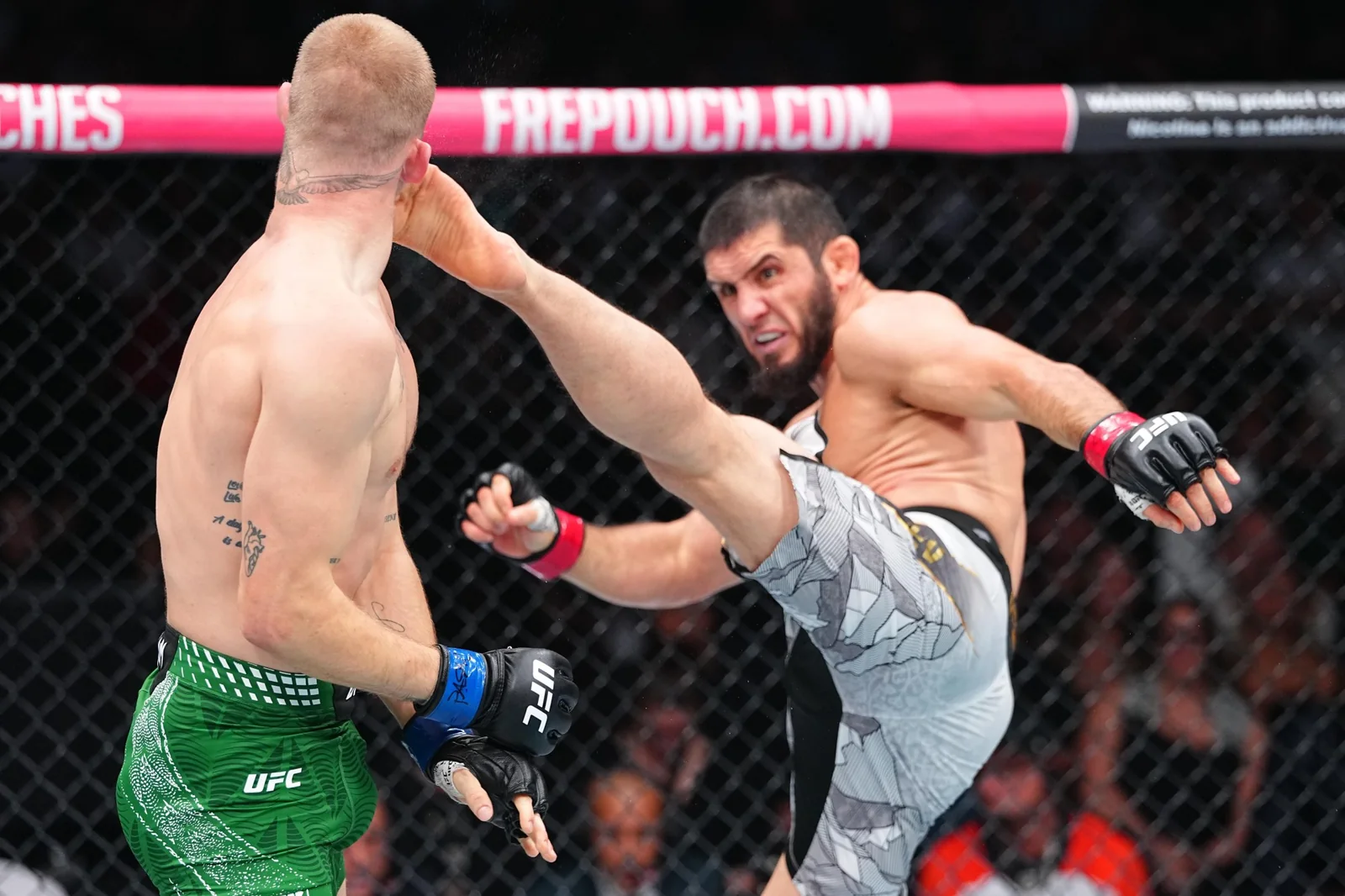 Islam Makhachev attacks Ian Machado Garry during the UFC 330 welterweight title fight
