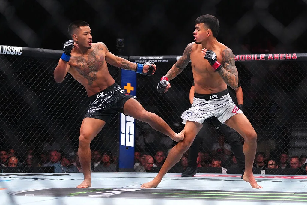 Joshua Van lands a kick on Brandon Royval during their UFC flyweight bout