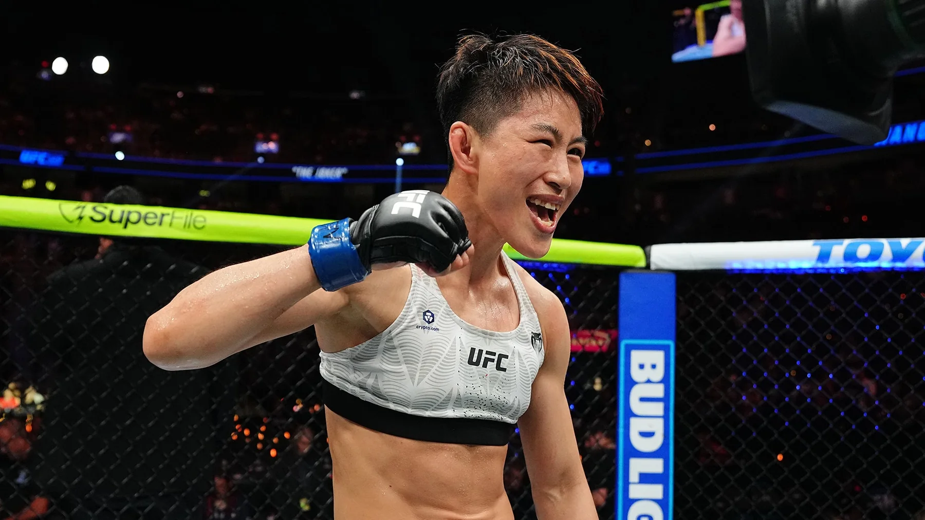 Wang Cong celebrates inside the UFC Octagon