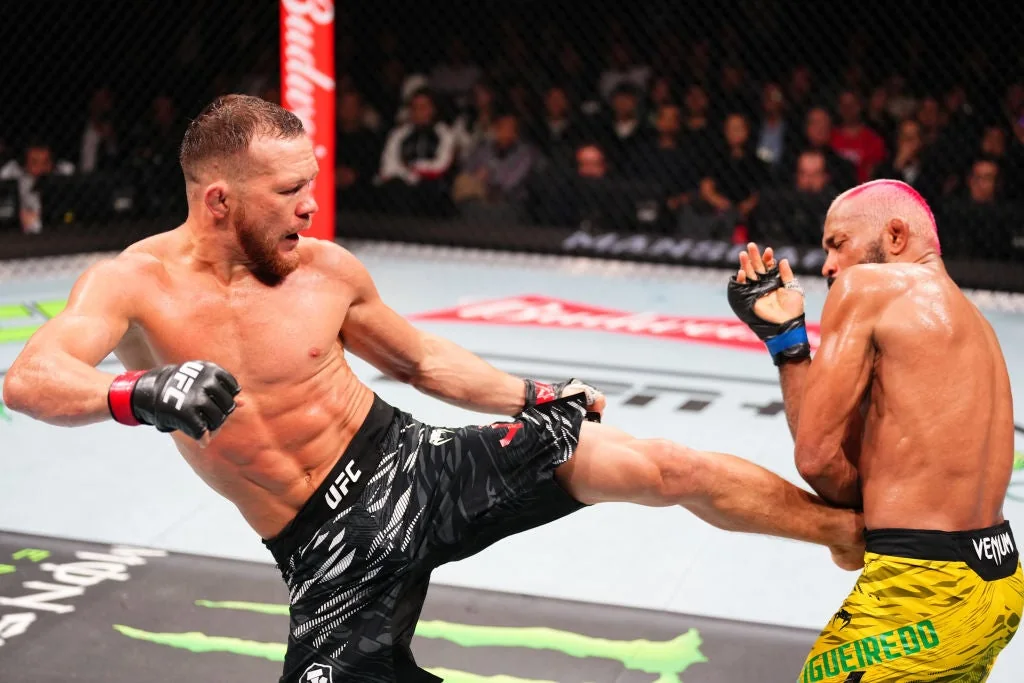 Petr Yan kicks Deiveson Figueiredo during their UFC Macau bantamweight fight