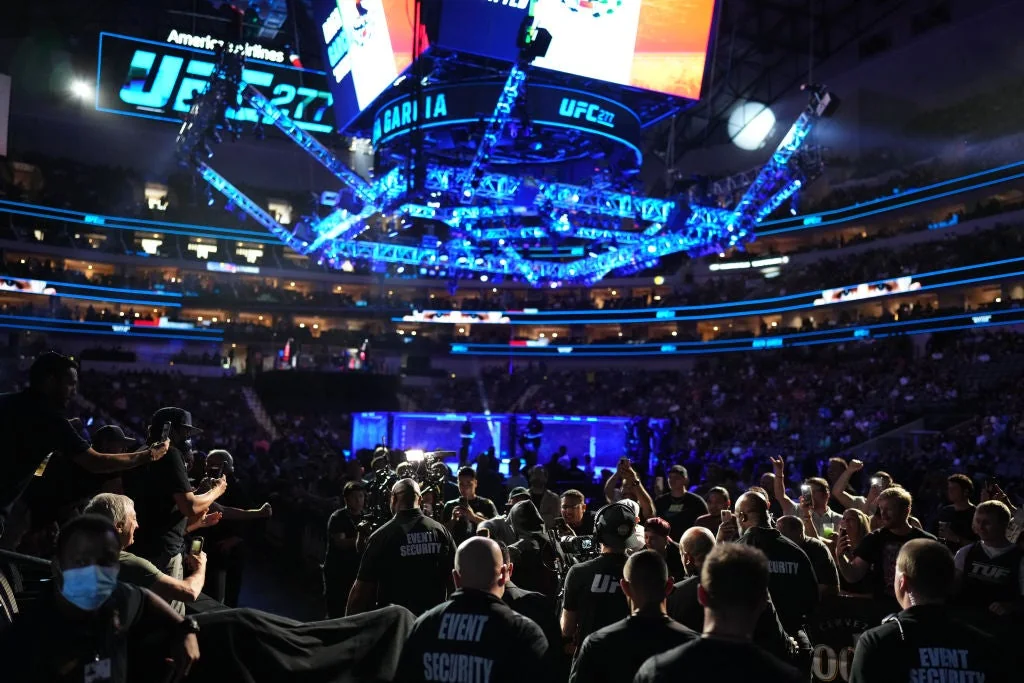 UFC fans gathered beside the fighter walkout route inside an arena
