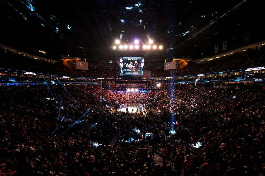 Wide arena view showing a UFC Octagon and surrounding seating bowl