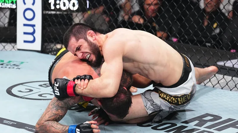 Islam Makhachev grapples with Renato Moicano during UFC 311 at Intuit Dome