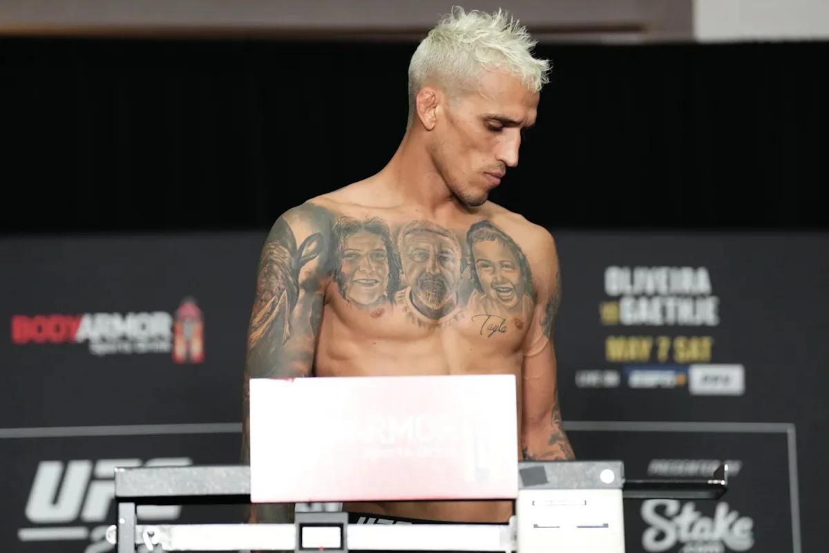 Charles Oliveira standing on the scale at the UFC 274 official weigh-in