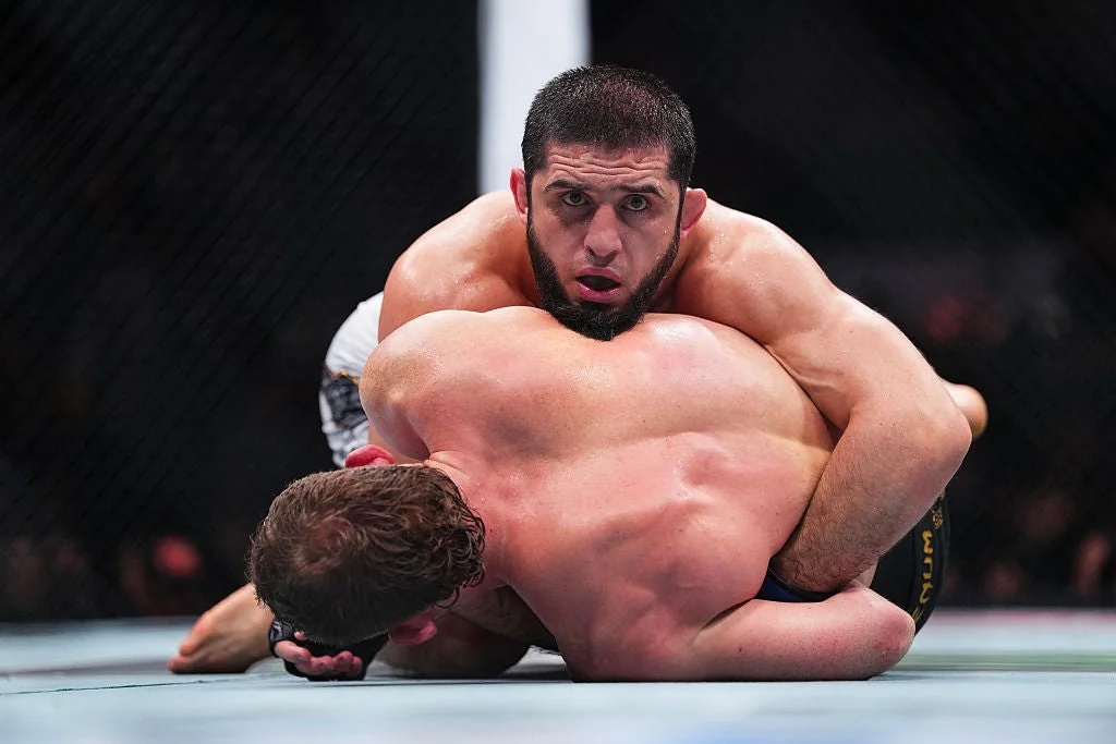 Islam Makhachev controls Jack Della Maddalena on the mat during their UFC 322 welterweight title fight